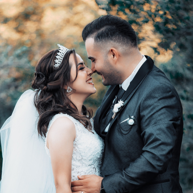 Wedding photoshoot with bride and groom looking into each others eyes in a romantic way