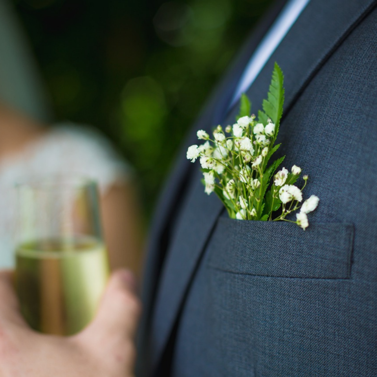 Boutonnière flowers in a Groom's lapel on wedding day.