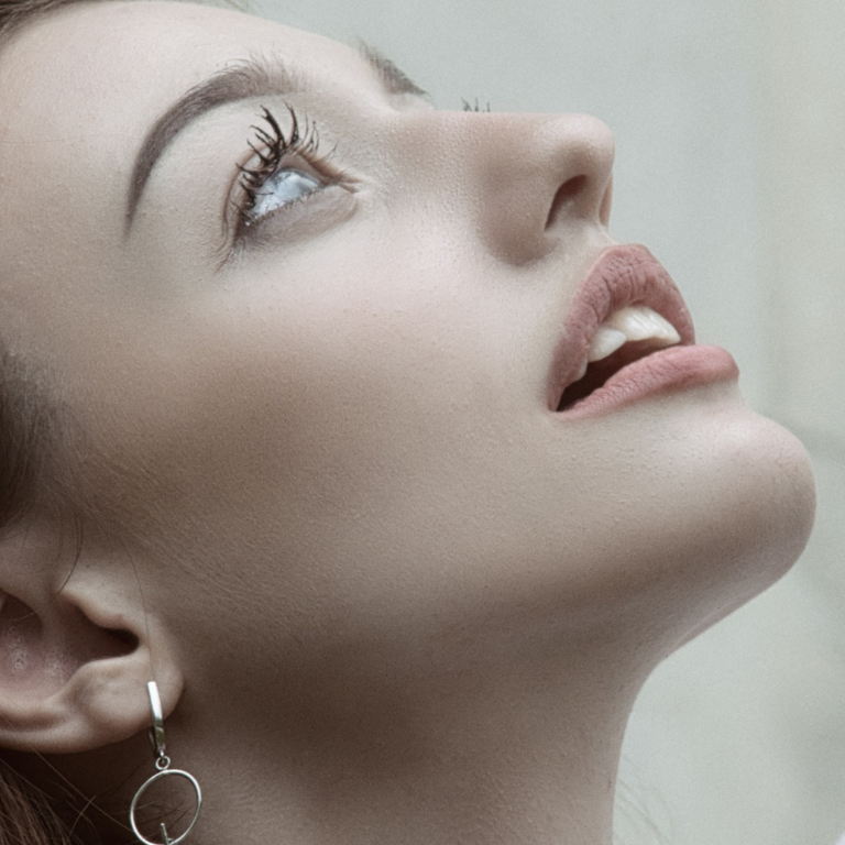 Headshot portrait of a lady looking up in the sky