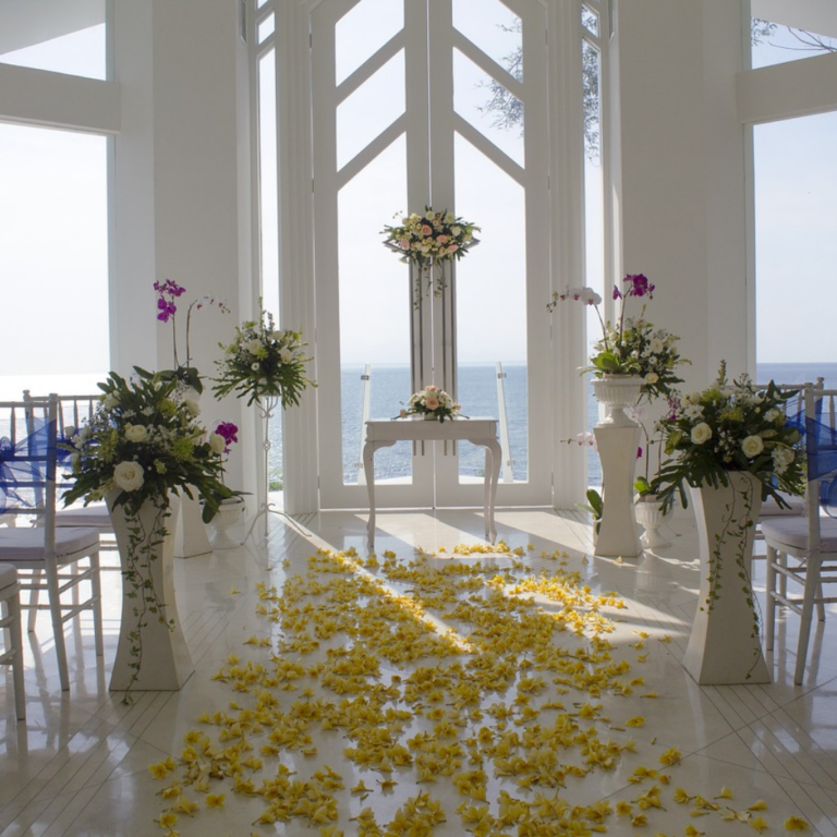 Destination Wedding location by the sea, with white furniture, decoration and flowers