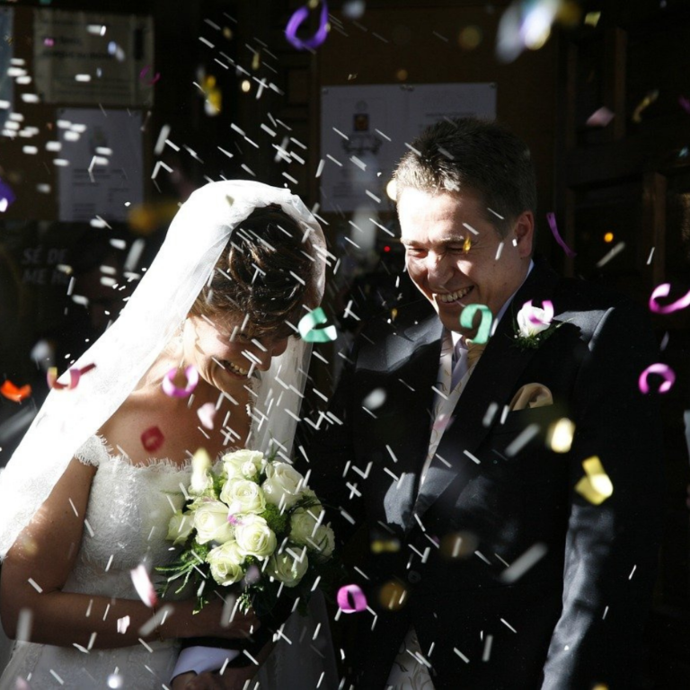 Wedding couple sprayed with confetti