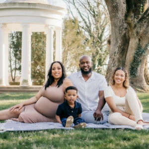 Outdoor photoshoot for a family of four, father, mother, boy, and girl in a picnic setting