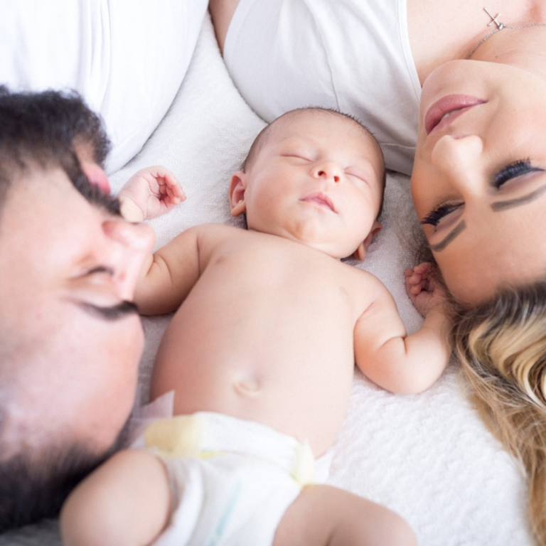 Family photoshoot for a family of three, father, mother, and infant baby boy