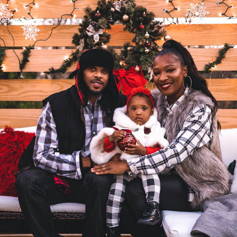 Christmas photoshoot by Quintessence Photography UK. A family of three, father, mother, and little baby girl