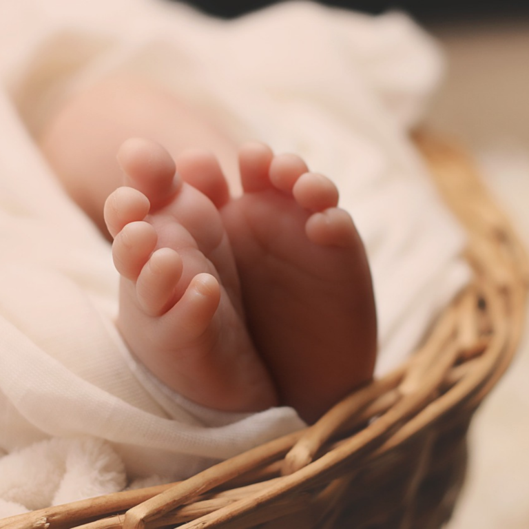 Baby photoshoot by Quintessence Photography UK, showing the infant's adorably cute little feet