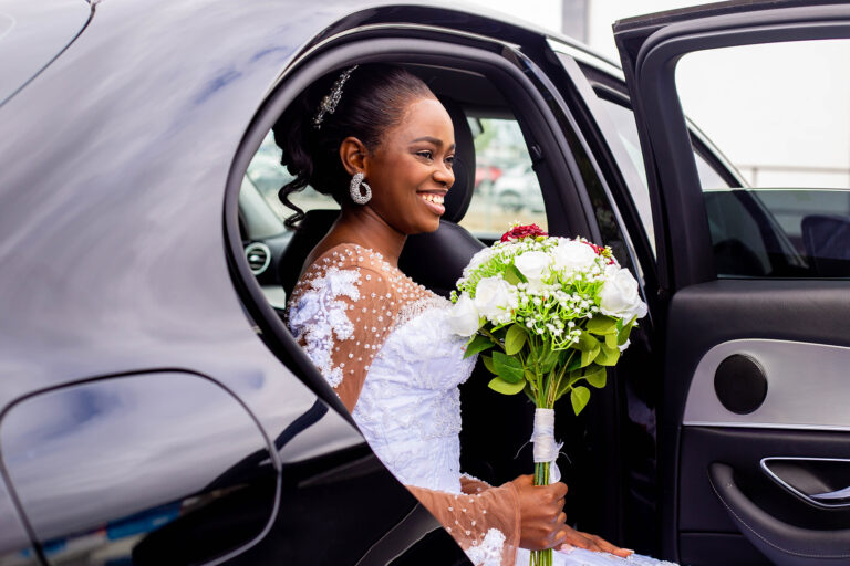 Wedding Photoshoot by Quintessence Photography UK as the bride steps out of the car