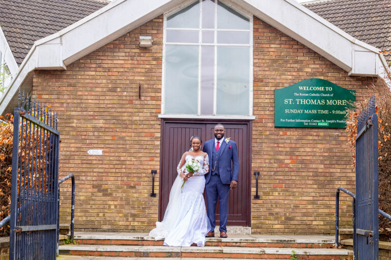 Wedding Photoshoot by Quintessence Photography UK. The couple alone in front of the church