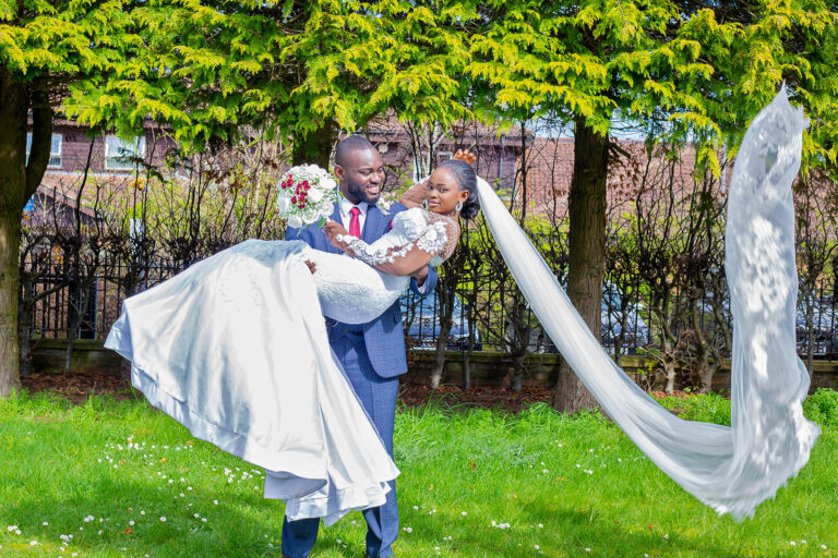 Wedding Photoshoot by Quintessence Photography UK as groom is carrying his bride